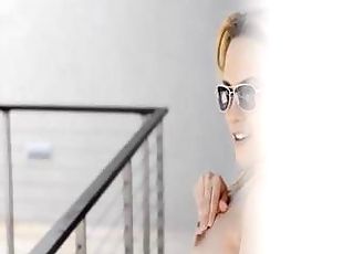 Young blonde in glasses plays with dildo