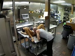 Bald dude eats out wet pussy in a restaurant's kitchen